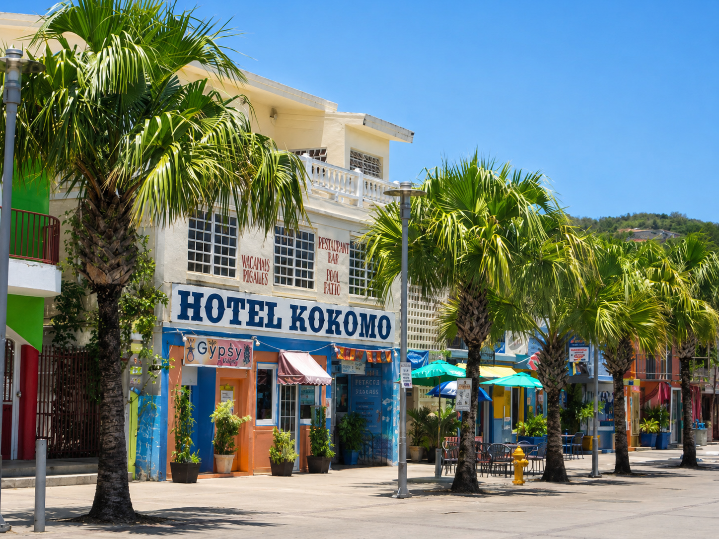 Colorful streetscape in Pueblo (Dewey), Culebra, with palms lining the Hotel Kokomo block